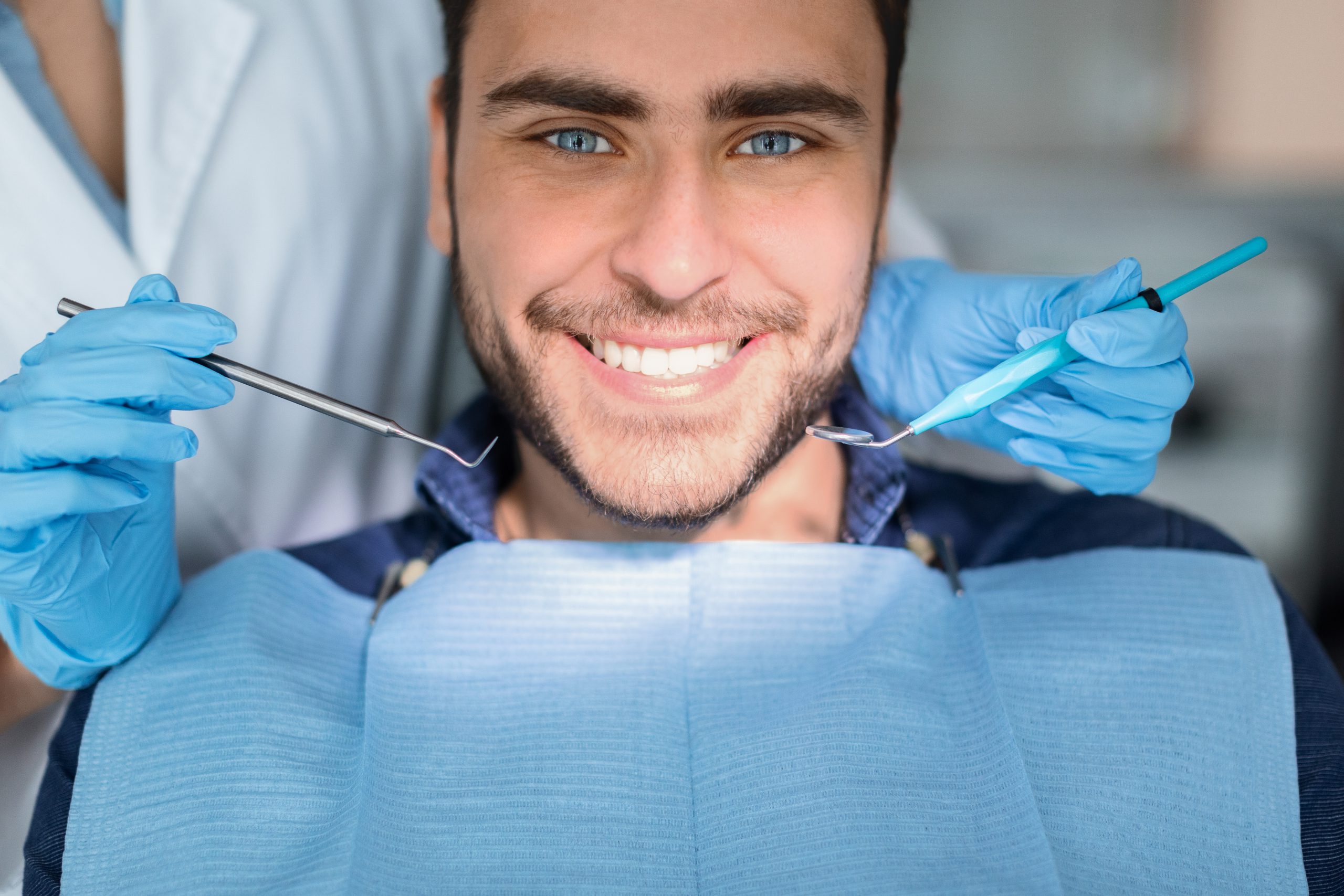 A man in the middle of procedure of smile designing