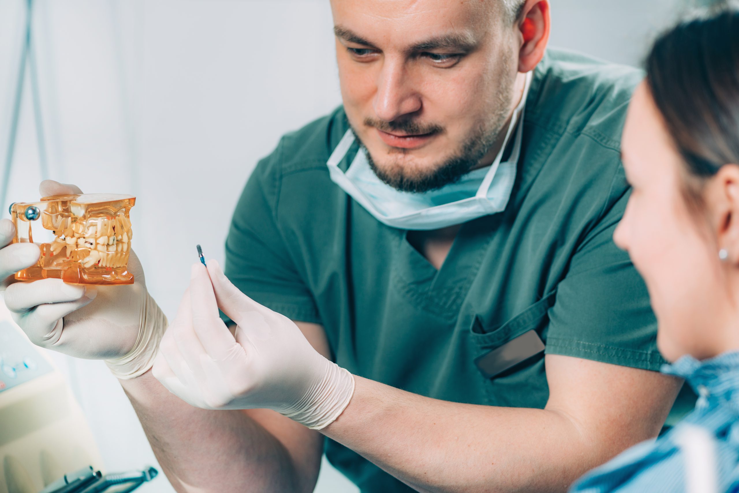 Diş implantı hastaya gösteriliyor