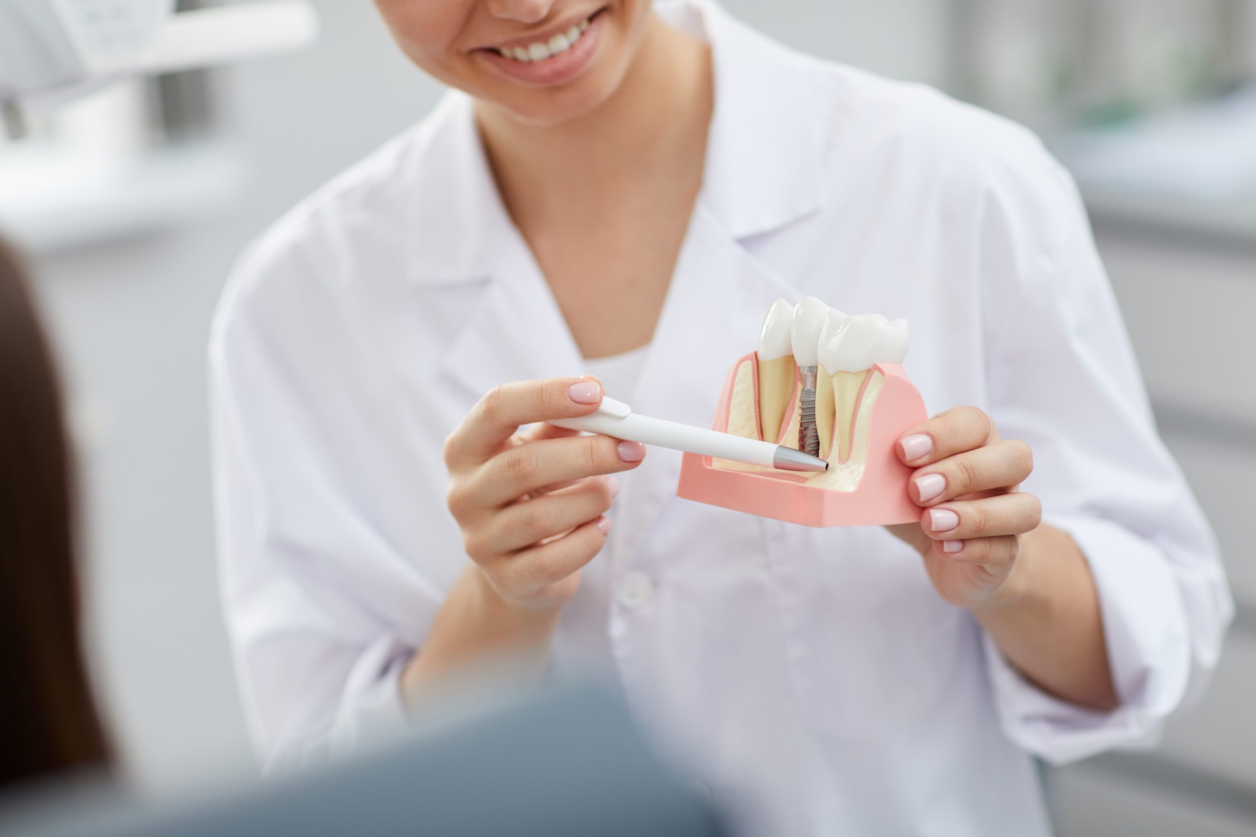 Dentist showing tooth to patient