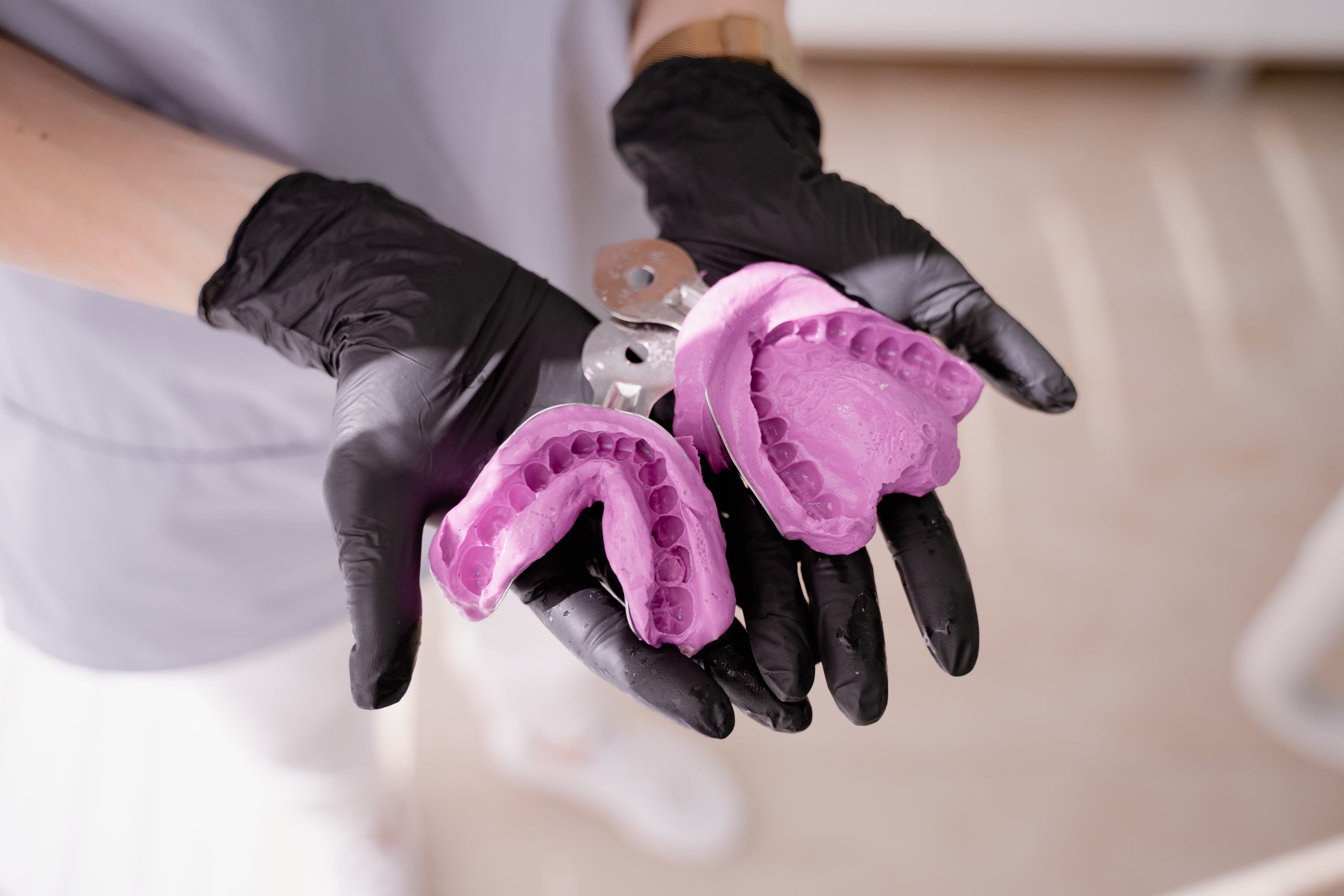 Dental prosthesis on hands of a dental assistant