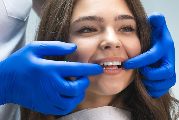 Dentist examines tooth alignment before dental crown placement