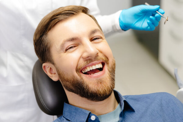 Happy patient smiling confidently after dental implant treatment at Natural Clinic, Istanbul.